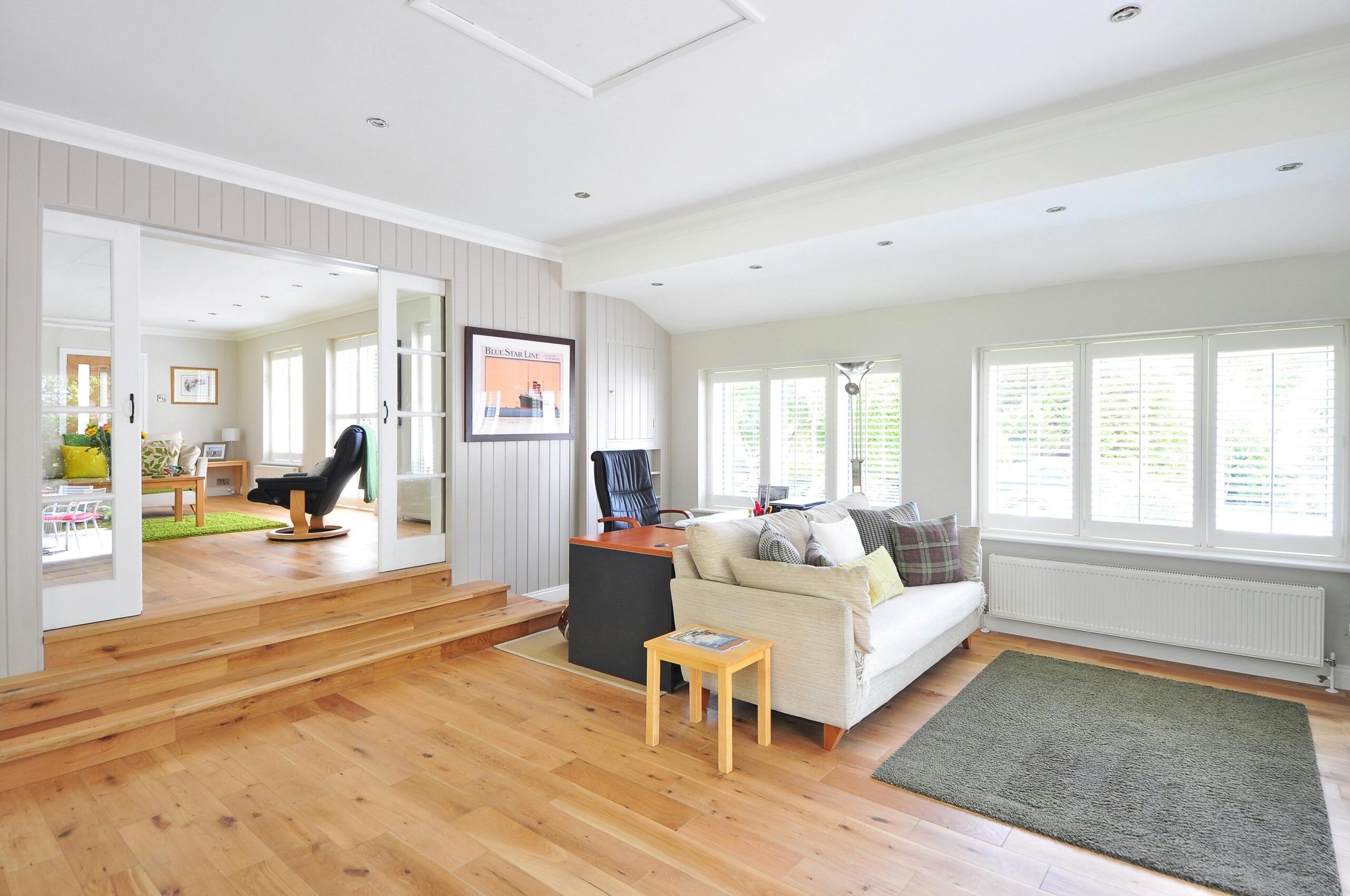 image of a room with wooden flooring and plantation shutters